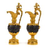 *Ewers. A substantial pair of modern gilt metal ewers, heavily cast with cherubs, grapes and