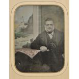 *Ambrotype. A full-plate hand-painted ambrotype of an unidentified man, circa 1870, the seated man