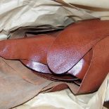 *Leather. Approximately forty skins of burnished brown 'Ganges' calfskin leather, mostly whole skins