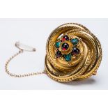 *Brooch. A Victorian 14ct gold brooch, formed as overlapping swirls set with garnets and semi-