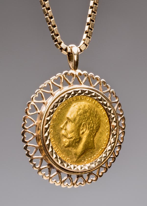 *Sovereign. A George V gold sovereign, 1919, mounted in a 9ct gold pendant with box link chain,