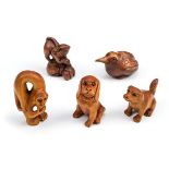 *Netsuke. A collection of five Japanese carved wood netsuke, comprising a rat standing on a bag,