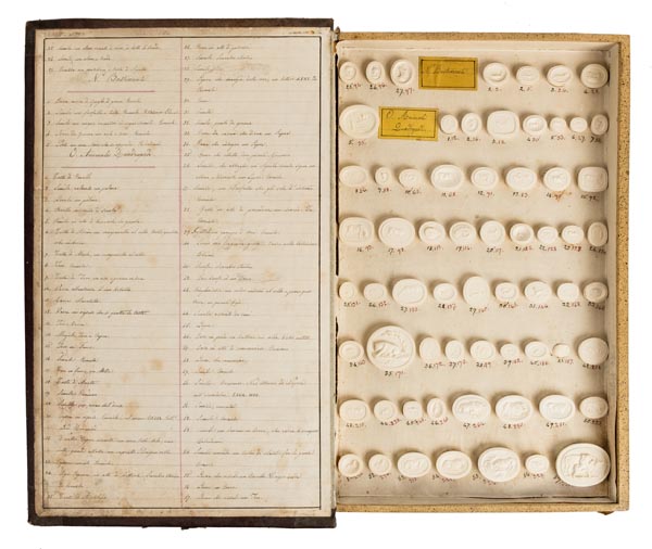 *Grand Tour. A 19th century book form box, containing 138 classical plaster seals, Impronte Gemmarie