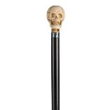 *Walking Stick. A 19th century walking stick, with carved ivory skull knop on ebony shaft with