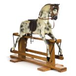 *Rocking horse. A dapple grey rocking horse by Haddon, circa 1970s, carved wooden rocking horse with