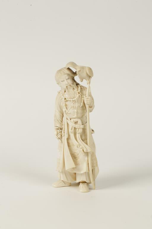 A JAPANESE ONE PIECE CARVED ELEPHANT IVORY FIGURAL OKIMONO "The Falconer", well detailed, an empty