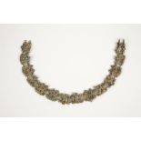 A GILT METAL EGYPTIAN REVIVAL CHOKER composed of fourteen pierced panels depicting Egyptian