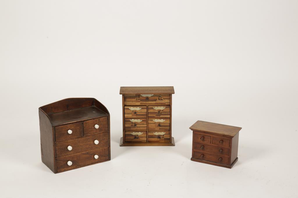 A MINIATURE VICTORIAN CHEST OF TWO SHORT AND TWO LONG DRAWERS with raised back and small ceramic