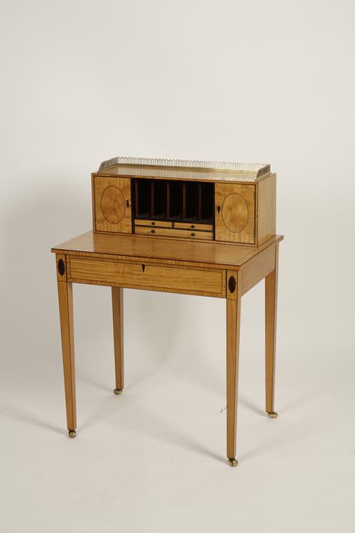 A SHERATON REVIVAL SATINWOOD LADIES WRITING DESK, the upper section with three-quarter pierced brass