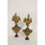 A PAIR OF ELABORATE CARVED GILTWOOD AND PAINTED WALL APPLIQUES of rococo vase-form, surmounted by