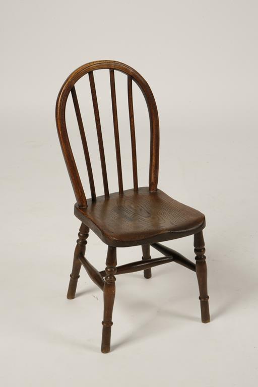 A MINIATURE WINDSOR CHAIR with hooped back, solid seat and turned legs and stretchers, 19th/20th