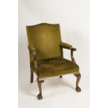 A GEORGE III MAHOGANY ARMCHAIR, the rectangular back with serpentine top rail above padded arms on