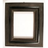 A DUTCH STYLE RIPPLE MOULDED EBONISED PICTURE OR MIRROR FRAME with swept and moulded surround, 36.