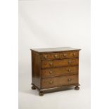 A QUEEN ANNE BURR VENEERED CHEST OF DRAWERS, the rectangular top with quarter matched veneers within