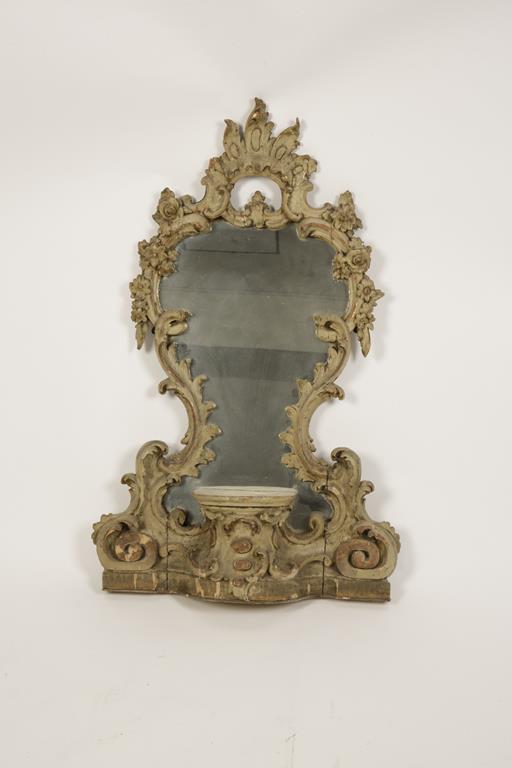 A CARVED AND PAINTED ROCOCO STYLE CARTOUCHE MIRROR, the waisted plate in an elaborate scrolling