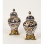 A PAIR OF JAPANESE IMARI PORCELAIN VASES AND COVERS