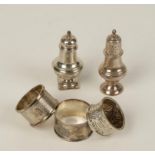 THREE NAPKIN RINGS and two pepper pots