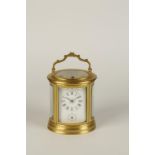 AN ORMOLU OVAL CARRIAGE CLOCK