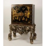 A WILLIAM AND MARY BLACK JAPANNED CABINET ON STAND