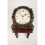 A CARVED MAHOGANY WALL CLOCK