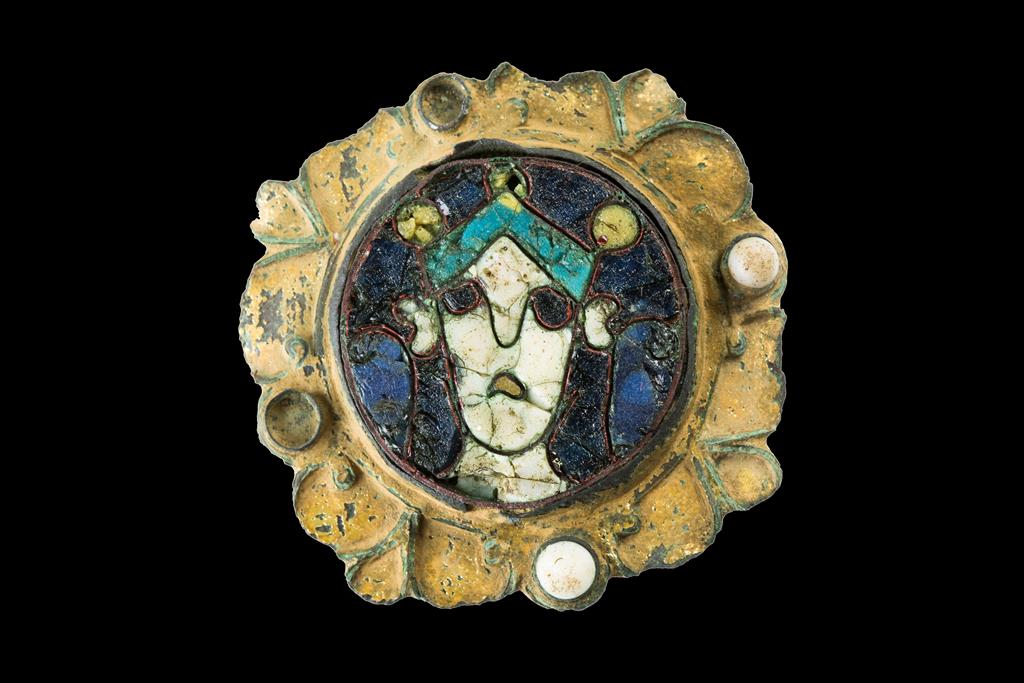 AN ANGLO-SAXON ENAMEL AND GILT METAL BROOCH, the enamel roundel in four colours, probably the head