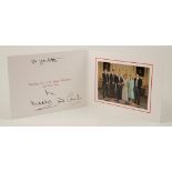 HRH THE PRINCE OF WALES AND CAMILLA: SIGNED CHRISTMAS CARD, with twin gilt embossed ciphers to cover