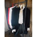 A SMALL COLLECTION OF VINTAGE COSTUME including a red tail coat and clothes worn by a previous