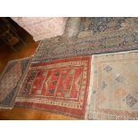 A PERSIAN STYLE CARPET worked with a central scrolling medallion against a blue ground within