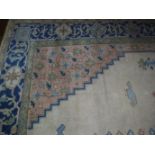 A LARGE GEOMETRIC CARPET worked with a central blue medallion surrounded by stylised foliage and