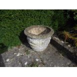 A LARGE PAIR OF RECONSTITUTED STONE PLANTERS of round tapering form with hanging ribbon-tied swag