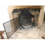 A 17TH CENTURY STYLE CAST IRON FIRE BASKET with moulded uprights, fireback, spark guard and fire
