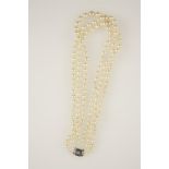 A TRIPLE STRAND CULTURED PEARL NECKLACE