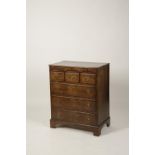 A NORFOLK TYPE WALNUT CHEST OF DRAWERS