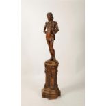A CONTINENTAL CARVED FRUITWOOD FIGURE OF A SERVING BOY