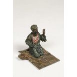 FRANZ BERGMAN: A CAST AND COLOURED BRONZE OF AN ARAB AT PRAYER