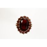 A GARNET DRESS RING