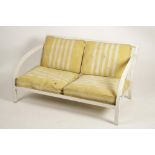 A MODERNIST METAL FRAMED TWO SEATER SETTEE