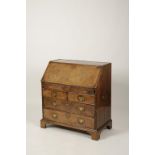 A GEORGE II WALNUT VENEERED BUREAU