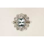 AN AQUAMARINE AND DIAMOND CLUSTER DRESS RING