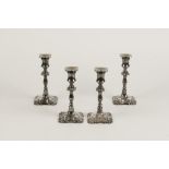 A SET OF FOUR GEORGE II STYLE VICTORIAN CANDLESTICKS