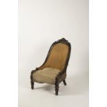 AN EBONISED AND UPHOLSTERED LOW CHAIR