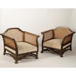 A PAIR OF EBONISED FRAME BERGERE ARM CHAIRS