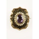 A 19TH CENTURY BLACK ENAMEL, AMETHYST AND SEED PEARL MOURNING BROOCH