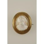 A RAISED CAMEO BROOCH