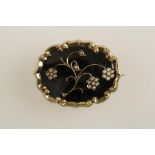 A BLACK ENAMELLED MOURNING BROOCH