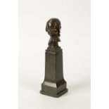 R.S: A CAST AND PATINATED BRONZE SCULPTURE A head and shoulders portrait of a young girl