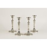 A SET OF FOUR EDWARDIAN CANDLESTICKS