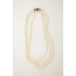 A TRIPLE STRAND CULTURED PEARL NECKLACE