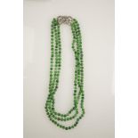 A THREE STRAND JADE AND DIAMOND NECKLACE