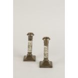 A PAIR OF EDWARDIAN SILVER MOUNTED CANDLESTICKS